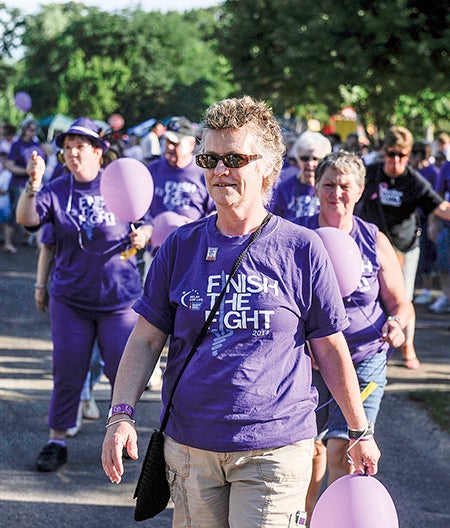 Mower County Relay for Life Honorary Chair Kelly Joseph leads the Survivor's Walk Saturday night at Bandshell Park.
