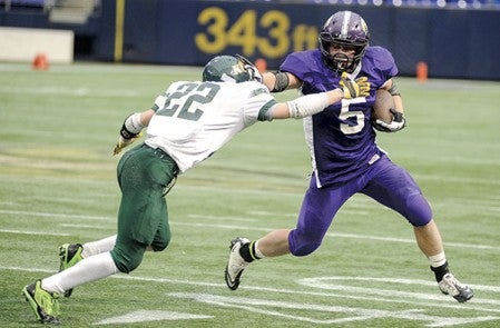 Grand Meadow’s Landon Jacobson stiff-arms Kittson County Central’s Nick Kasprowicz on a third-quarter run in the Minnesota State Nine Man semifinals in November at Mall of American Field in Minneapolis. Herald file photo