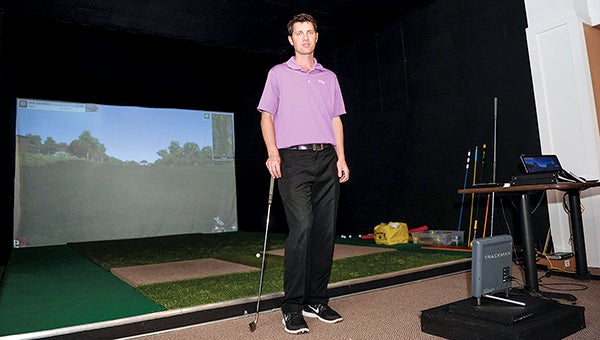 Aaron Ressler stands in front of a golf simulator he’s opening in Bunkies Grille and Lanes in Blooming Prairie. -  Eric Johnson/photdoesk@austindailyherald.com