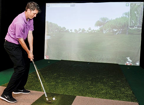 Aaron Ressler takes a shot on the golf simulator at Bunkies Grille and Lanes. The simulator will give golfers the opportunity to not only practice but play courses from around the world.