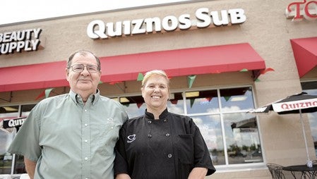 Norm and Marlene Blaser stand outside the Quinzos they own in the Target strip mall Tuesday morning. The couple has revealed that a potential buyer has come forward. -- Herald file photo
