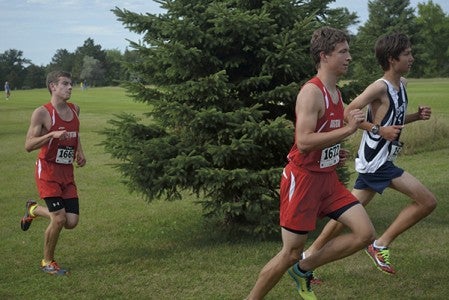Austin's Holden Ourada, right, and Mitchell Mayer, left, run for the Packer cross country team at Meadow Greens Golf Course Tuesday. -- Rocky Hulne/sports@austindailyherald.com