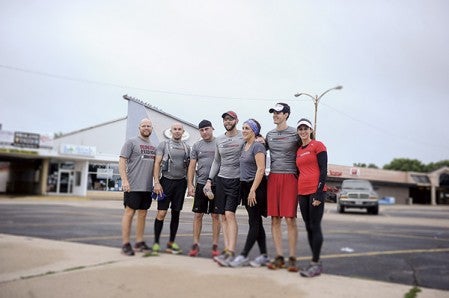 Kelly Nesvold and his team pose for a picture after completing their 50-mile test run early Saturday morning at Cornerstone Church. From left they are: Aaron Broberg, Eric Feuchtenberger, Tony Thoma, Nesvold, Danielle Nesvold, Todd Dube and Corinne Neitzell. Eric Johnson/photodesk@austindailyherald.com