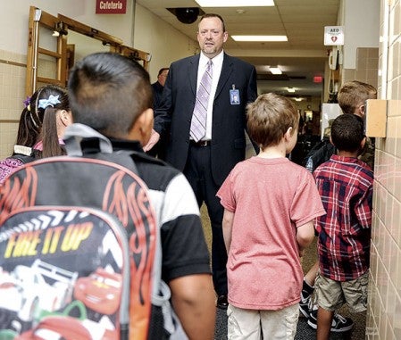 Neveln Elementary principal Dewey Schara greets students.