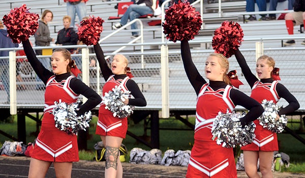 Cheerleaders cheer from the sidelines during the Packers football game against Albert Lea. -- Rocky Hulne/sports@austindailyherald.com