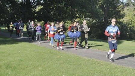 Runners begin the Superhero Dash 5K Saturday at Lafayette Park. Phots by Jenae Hackensmith/jenae.hackensmith@austindailyherald.com