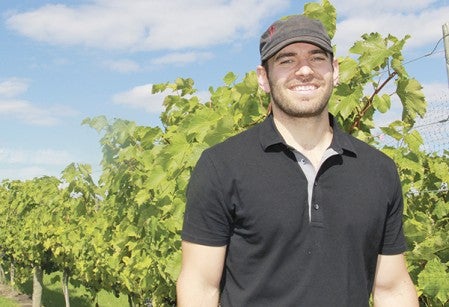 Winemaker Justin Osborne poses in the vineyard Saturday. 