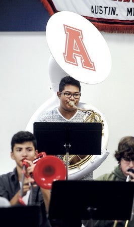 Jose Phomsoukha plays one of Austin band's two new sousaphones, part of the instruments bought with money from a fundraiser. Eric Johnson/photodesk@austindailyherald.com