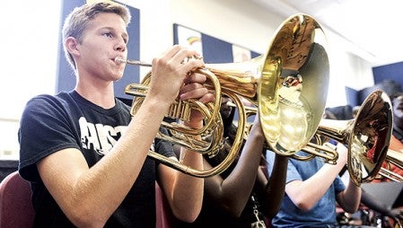 Corbin Munger plays the marching French horn during orchestra rehearsel Thursday. The instrument was one of several that were bought through a fundraising effort. Eric Johnson/photodesk@austindailyherald.com