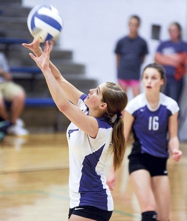 Grand Meadow's Rachel Oehlke sets the ball forward during game one of their match against Lyle-Pacelli Tuesday night in Lyle. Eric Johnson/photodesk@austindailyherald.com