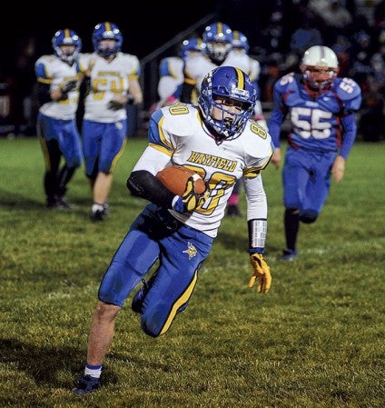 Hayfield's Colton Bjornson heads up-field after a catch in the third quarter against Southland Friday night in Adams. Eric Johnson/photodesk@austindailyherald.com
