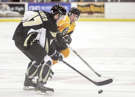 Austin Bruins' Luke Dietsch shadows Bismarck's Cole Soute during the second period Friday night at Riverside Arena. Eric Johnson/photodesk@austindailyherald.com