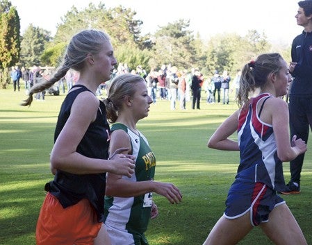 Pacelli's Sarah Kahle, middle, runs at the Austin cross country invite at Meadow Greens Course Monday. -- Rocky Hulne/sports@austindailyherald.com