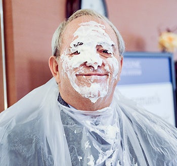John Coppes smiles through a face-full of whipped cream.