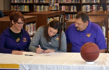 Taylor Hagen signs her national letter of intent to play basketball at University of Northern Iowa with David Hagen and Joan Hagen. -- Rocky Hulne/sports@austindailyherald.com