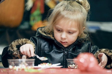 Four-year-old Madellane Hicks makes her own Christmas cookie at Hy-Vee during last year’s Christmas in the Northwest. Herald file photo
