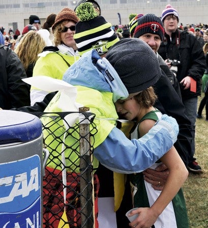 Pacelli's Kayla Christopherson is hugged by her aunt Jane Weiers after her run at the Class A state cross country in Northfield Saturday. -- Rocky Hulne/sports@austindailyherald.com