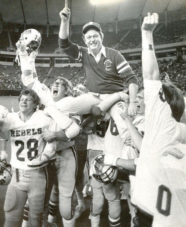 Dick Strand is carried off the field after the Southland Rebels won the 1983 Class C state football championship.  Photo Provided