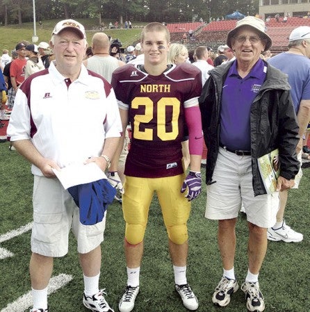 Dick Strand, left, was an honorary coach against his grandson Michael, middle, at the last Minnesota North-South All-Star football game.  