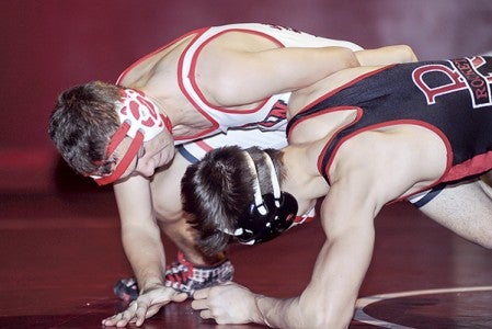 Austin's Aiden Wilson gains the advantage on Rochester John Marshall's Steven Bruggenthies at 132 pounds last year. Herald File Photo