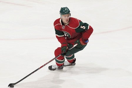 Christian Folin of the Minnesota Wild handles the puck against the Anaheim Ducks during the game on Dec. 5, 2014, at the Xcel Energy Center in St. Paul, Minnesota. Photo by Bruce Kluckhohn/NHLI via Getty Images