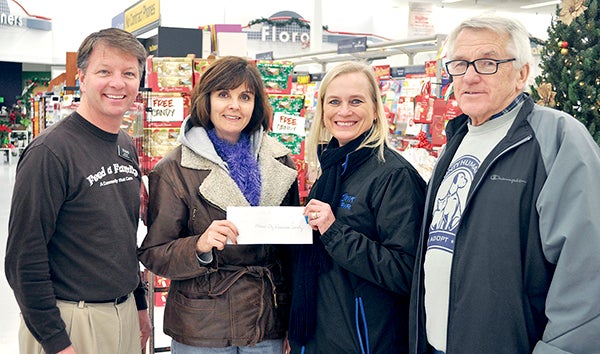 Hy-Vee Store Manager Todd Hepler (left) accepts a check for $1,000 from Mower County Humane Society President Peggy Olson, local Donella Hastings, and humane society volunteer Barry Rush for the humane society’s animal food and litter. Hepler added 20 percent to the check, so the tab has $1,200. -- Jenae Hackensmith/jenae.hackensmith@austindailyherald.com