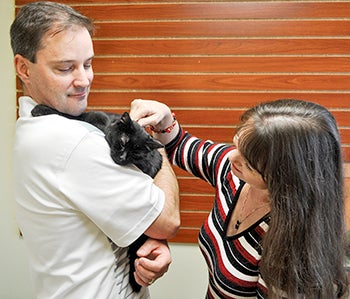 Robert and Robin Hanson hold their new cat Freddie Mac as they go through the adoption process at the Mower County Humane Society Tuesday. Freddie Mac had been at the shelter about six years. The couple had adopted two cats from the shelter previously.