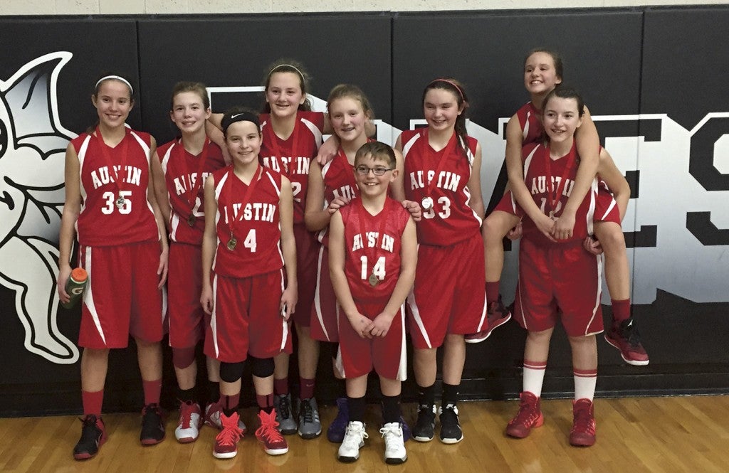 The 7th grade Austin Youth Basketball team took second place in in the Blooming Prairie tournament Dec. 6. Back row: (left to right): Brittany Wolter, Erica Lundberg ,Emily Bollum, Destiny Gray, Carly Snee, Ellie Tupy and Elyse Hebrink; front row Grace Mayer and team manager Cale Tupy. -- Photo Provided