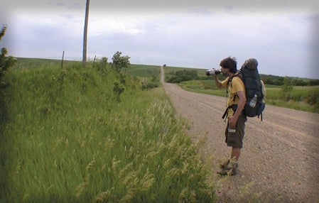 Mark Phillips stops to take a drink on his trek across America in 2001. Photo provided