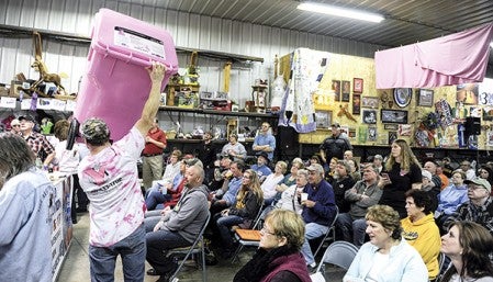 A pink garbage can once belonging to Tracy Schilling is held up. It was given to the Lyle Area Cancer Auction by Dave Yerhart of Y Waste Disposal. All cans collected in it will be recycled with funds given to Lyle Area Cancer. 