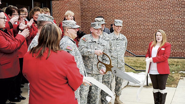 Sgt. 1st Class David Gansen cuts the ribbon as the National Guard celebrated the reopening of the armory. 