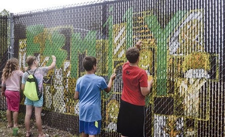 A group of students with Pacelli’s summer STAM camp help paint a mural behind the old utilities building. Pacelli took part in Vision 2020's Graffeti to Art program which received a grant from the Austin Area Foundation. Herald file photo