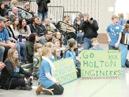 I.J. Holton Engineers cheer with their classmates on and hold up encouraging signs during a match at the robotics state tournament over the weekend. Photos provided.