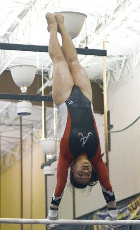 Jennifer Boyle peforms on the bars for the Packers in the Austin YMCA Tuesday. -- Rocky Hulne/sports@austindailyherald.com