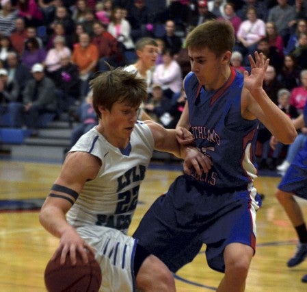 Lyle-Pacelli's Jordan Hart is guarded by Southland's Jared Landherr in Adams Monday. -- Rocky Hulne/sports@austindailyherald.com