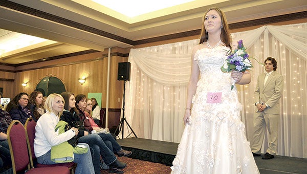 Model Katie Subra shows off a wedding dress at the Austin Wedding Showcase inside the Hormel Historic Home last year. Herald File photo