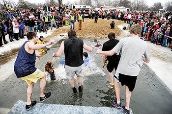 Big Jake’s Jumpers make their jump during the Polar Plunge Saturday afternoon at East Side Lake.