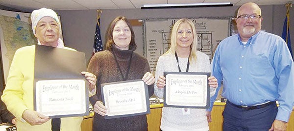 Ramona Sack, Beverly Atzl, and Megan DeVos of Mower County’s Health and Human Services Department were named the county’s employees of the month during a county board meeting Tuesday.  Sack, Atzl and DeVos were nominated by Susan Wagner, shown accepting Sack’s award, for taking up Wagner’s case load when she was out on medical leave. Photo provided