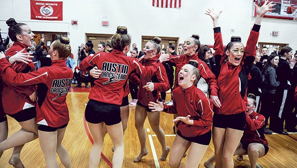 The Austin Packers Dance Team celebrate after claiming the Section 1AA title last Saturday in High Kick in Packer Gym.