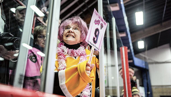 Sue Stowell clenches her teeth as she bids for Landen Letwin’s jersey during the jersey auction Saturday at Riverside Arena. Stowell won the jersey.  Eric Johnson/photodesk@austindailyherald.com