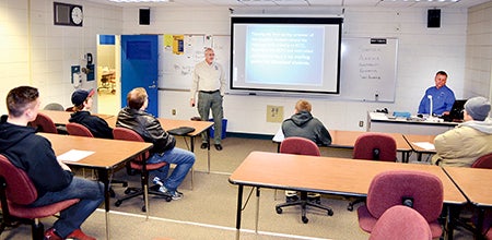 Program Coordinator and Facility Instructor Steve Wald and Facility Instructor Rich Watkins talk to prospective students about the law enforcement program.