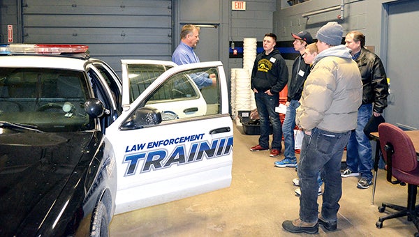 Facility Instructor Rich Watkins shows prospective students the simulation lab and one of the squad cars for the law enforcement program at Riverland Community College in Austin Thursday afternoon. -- Photos by Jenae Hackensmith/jenae.hackensmith@austindailyherald.com