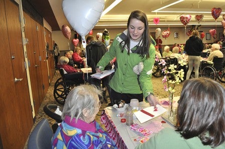 Austin High School's National Honors Society gives Valentine's Day cards to seniors Friday at St. Mark's Living.  