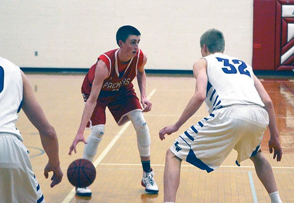 Austin's Levi Vierkandt handles the ball against Red Wing in Packer Gym Friday. Rocky Hulne/sports@austindailyherald.com