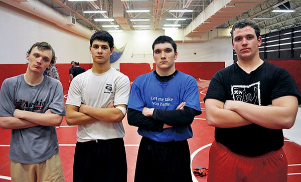 From left: Austin captains Nathan Brinkman, Brandon Cotter, Kole Igou and Eli Kaercher are looking forward to the Section 1AAA wrestling meet this Friday and Saturday at Mayo Civic Center in Rochester. Rocky Hulne/sports@austindailyherald.com