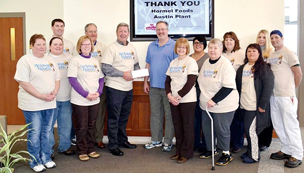 Employees on the Hormel Plant’s Helping Hands committee raised donations in various ways to support the Institute’s breast cancer research. - Photo provided 