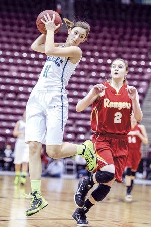 Lyle-Pacelli's Sarah Holtz takes a pass and looks to the basket in front of Mountain Iron-Buhl's Lauren Dage during the first half in the Class A Minnesota State Girls Basketball Tournament quarterfinals this winter in Mariucci Arena. Herald File Photo