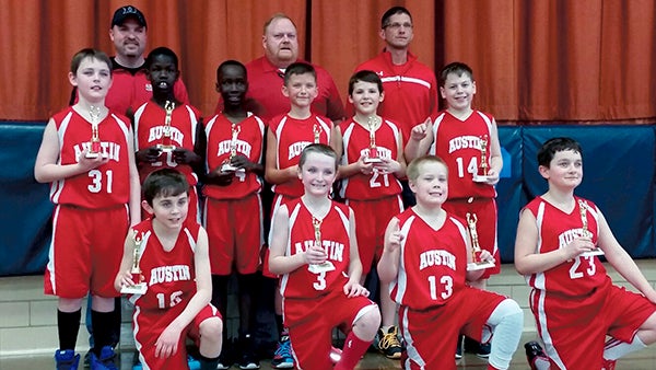 The Austin 4th grade boys basketball team took first place in the Fairmont Tournament March 7. Back row (left to right): coach Steven Lang, coach Jerry Cannon and coach Jeremy Herrick; River Graff, Cham Okey, Morries Jabateh, Jacob Herrick, Joe Ewing and Luke Owens; front row: Ryder Bergstrom, Jack Lang, Carson Cannon and Aiden Oharra. Photo Provided
