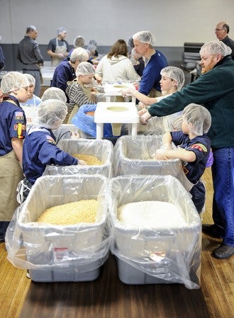 Cub Scouts packed food Saturday morning for Real Hope for the Hungry at the Austin VFW. Eric Johnson/photodesk@austindailyherald.com