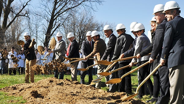 Area officials break ground for a new apartment complex Monday morning. The Hormel Foundation and Hormel Institute announced the 42-unit Science Park Housing complex will begin construction in May and be ready for occupancy in January. Trey Mewes/trey.mewes@austindailyherald.com